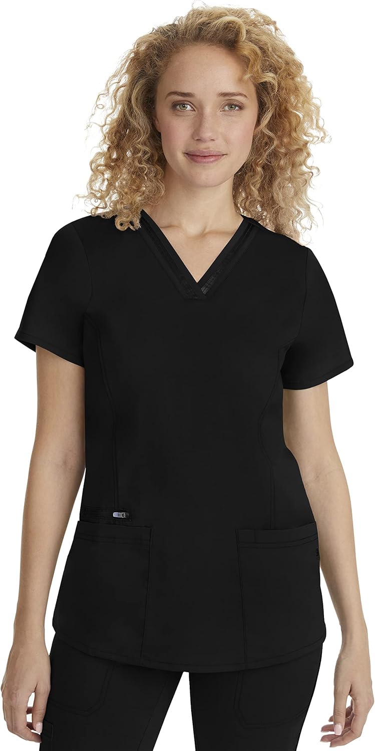 Healing Hands women's scrub top displayed on a wooden changing bench with pockets open showing medical tools